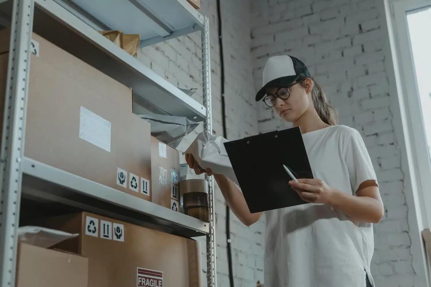 Woman inspecting packages in warehouse