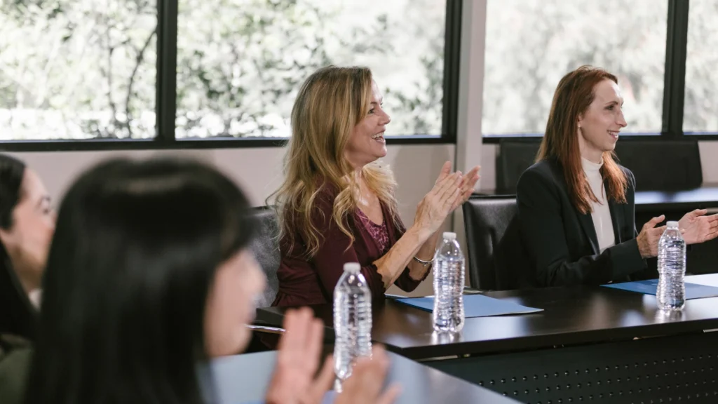 Participants applauding during a professional development workshop.