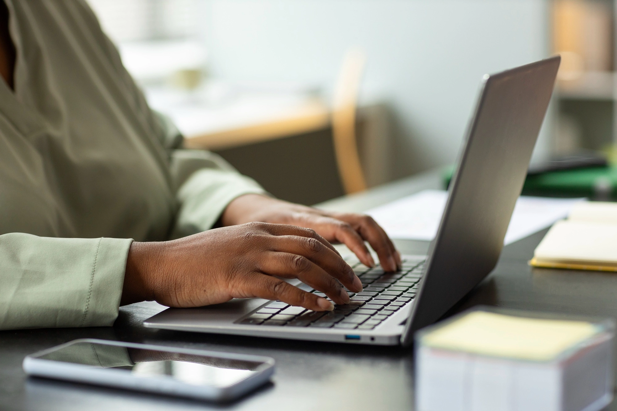 Woman filling in a form on a laptop